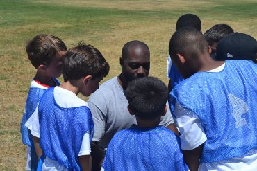 Local youngsters treated to NFL player and local football legend at annual summer camp George Gaffney, Ausberry's brother, gives a group of camp participants tips on football.
